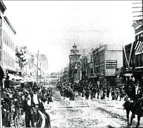 A parade on the 300 block of South Elm Street circa 1900